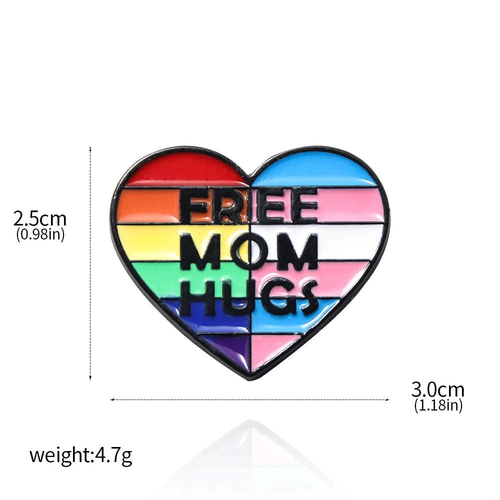 The Free Mom Hugs rainbow and trans pride flag love heart badge is a 2.5cm x 3.0cm pin with “FREE MOM HUGS” in bold letters, weighing 4.7g, perfect for celebrating love and support for all.