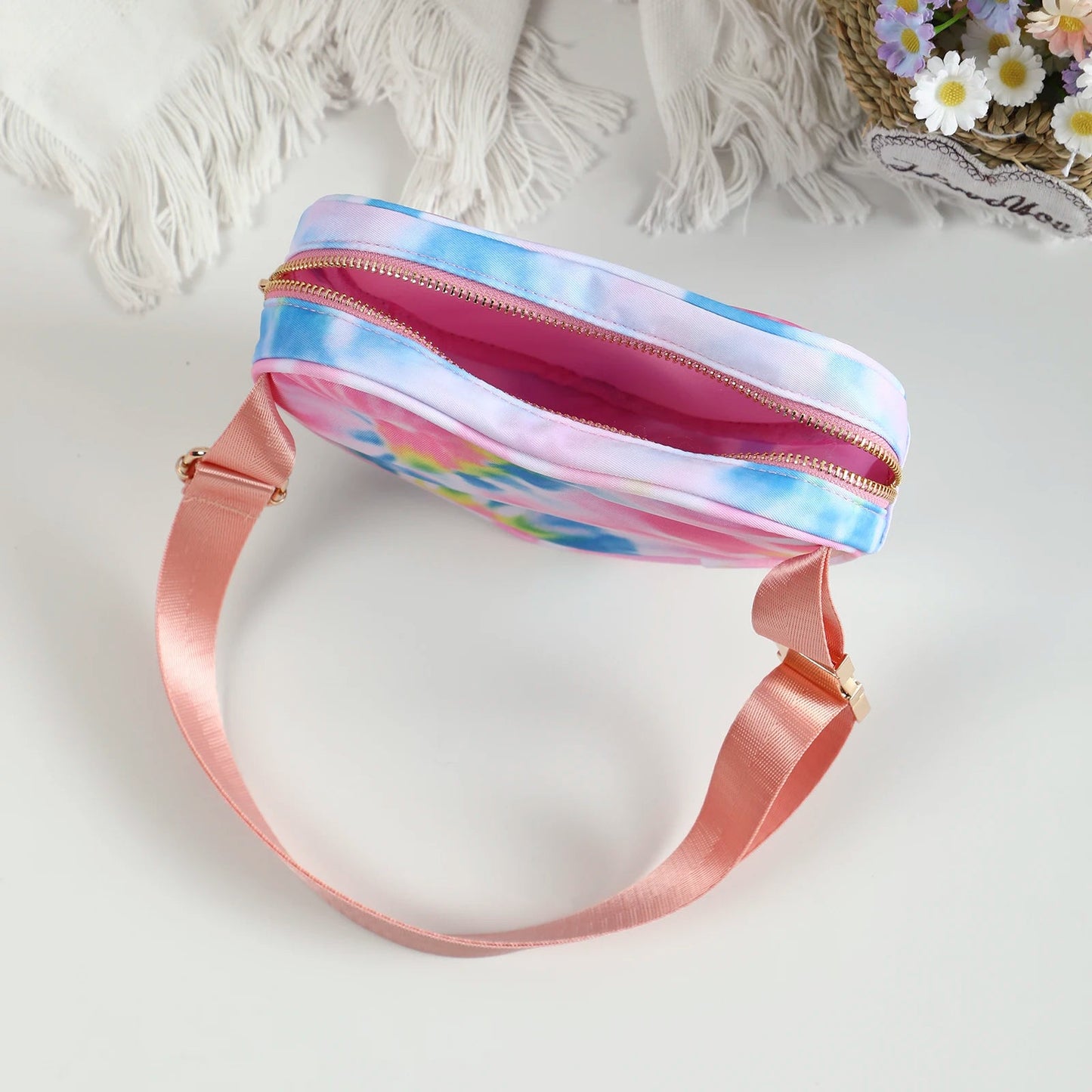 Love heart shaped bag with waist strap and gold details. This Heart Shaped Crossbody Bag or Fanny Pack is perfect for your skating adventures. Its unique love heart design is a fashionable statement piece, while the bag's practicality offers hands-free convenience. Available in kawaii shades of pink, teal, and tie dye, or make a bold statement with red.