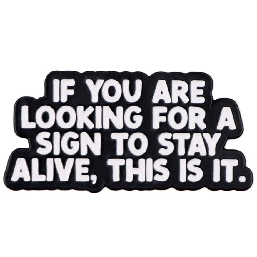 If You Are Looking For A Sign To Stay Alive, This Is It, black and white enamel pin measuring 2cm x 4cm. Suicide Prevention badge
