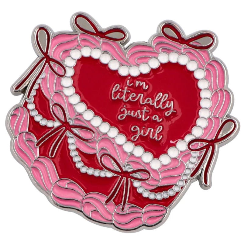 The "I'm Literally Just A Girl" pin by Gay Skate features a heart-shaped design resembling a cake in pink and red, adorned with white beads and bows, with cursive text at the center.