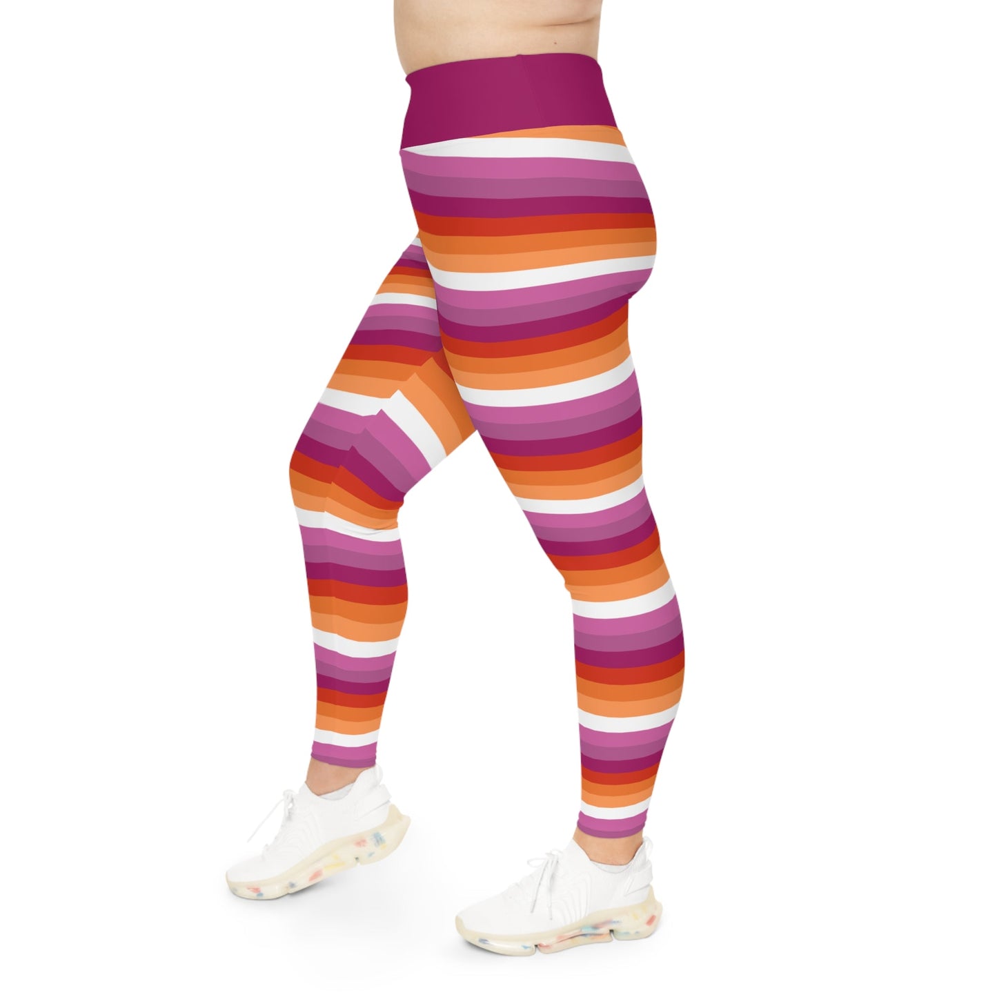 A person wearing Printify's Lesbian Pride Plus Size Leggings (available in sizes 2XL - 6XL), featuring vibrant stripes in colors reminiscent of the Lesbian Pride Flag. They are paired with white platform sneakers against a plain white background, showcasing only the lower half of the body.