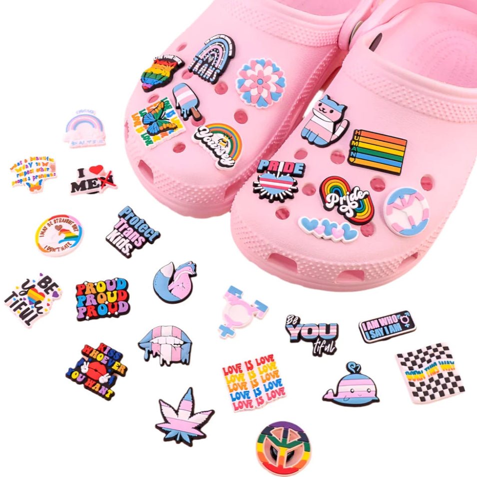 LGBTIQA Shoe Jibbitz, sets of crocs clogs shoe charms designed to enhance your Crocs. These vibrant accessories feature colorful LGBT themed designs such as rainbows and pride flags. Additionally, you can personalize your footwear with charms that spell out empowering messages like "Pride" and "Love is Love.