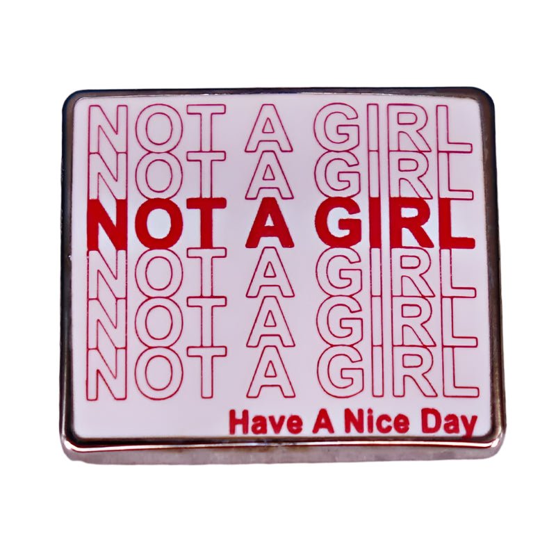 Enamel pin with 'Not a Girl' red text pattern on a white background