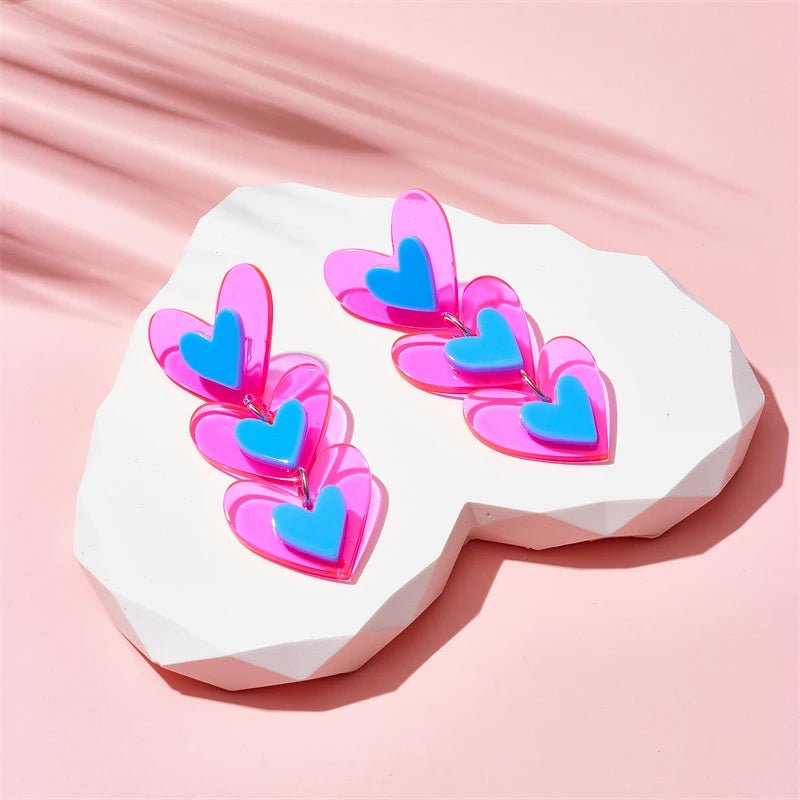 Pair of pink and blue heart-shaped earrings for trans pride