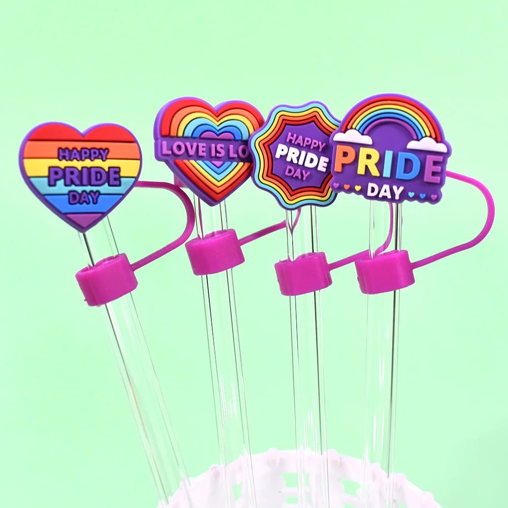 Four transparent straws with Pride straw toppers designed for Stanley Cup straws display vibrant colors. The rainbow designs include messages like "Happy Pride Day" and "Love is Love," celebrating inclusivity and joy.
