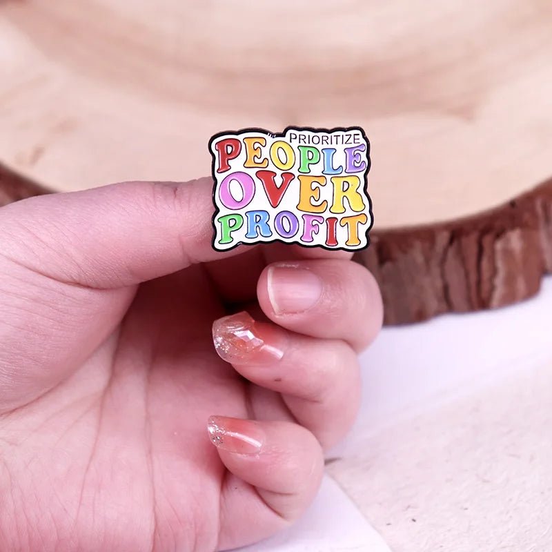Prioritize People Over Profit rainbow enamel pin