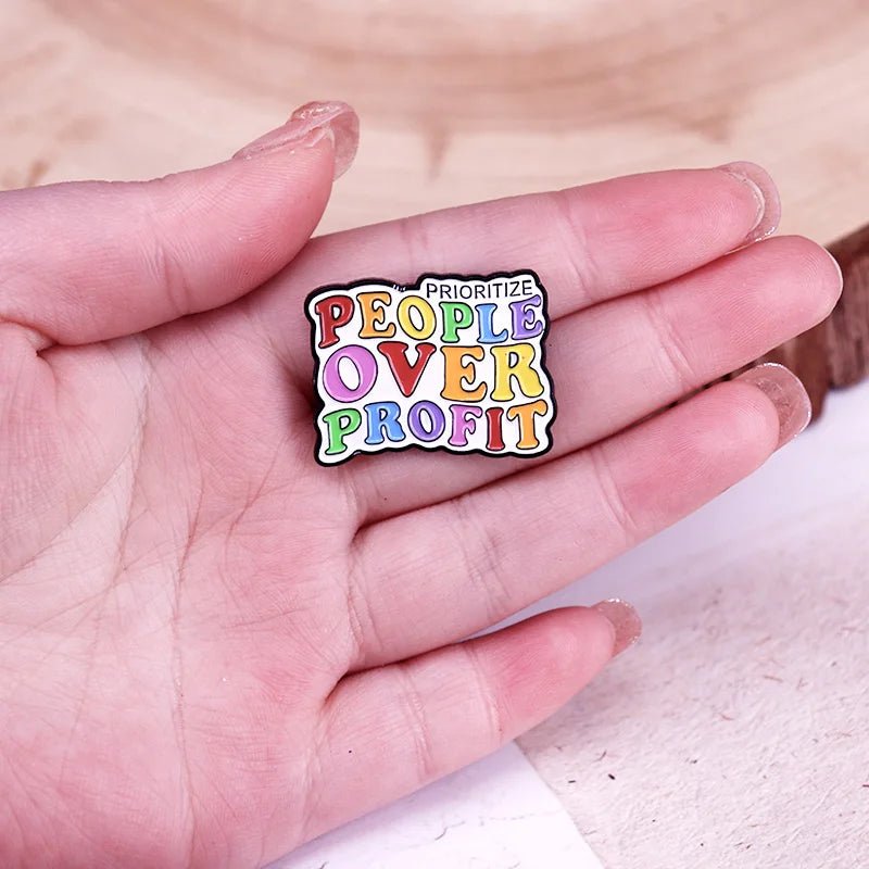 Prioritize People Over Profit rainbow enamel pin