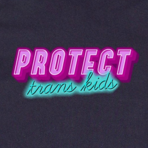The "Protect Trans Kids" - Local hand printed t-shirt by Gay Skate is a black AS Colour shirt showcasing the phrase in eye-catching pink and blue lettering, echoing the colors of the Transgender Flag, and elegantly set against a vibrant green grass backdrop.
