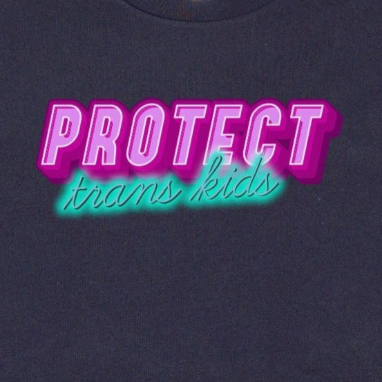 The Gay Skate's "Protect Trans Kids - original design - locally printed crop tee" is a black crop top t-shirt that proudly displays the text "PROTECT trans kids" in bold, vibrant pink and teal letters across the chest. The eye-catching font and incorporation of transgender pride flag colors make it a standout piece in queer skate and streetwear.