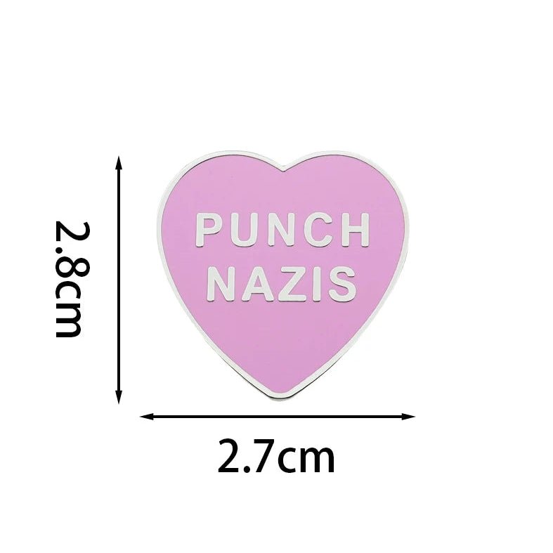 Heart-shaped pink and silver enamel pin with 'Punch Nazis' text