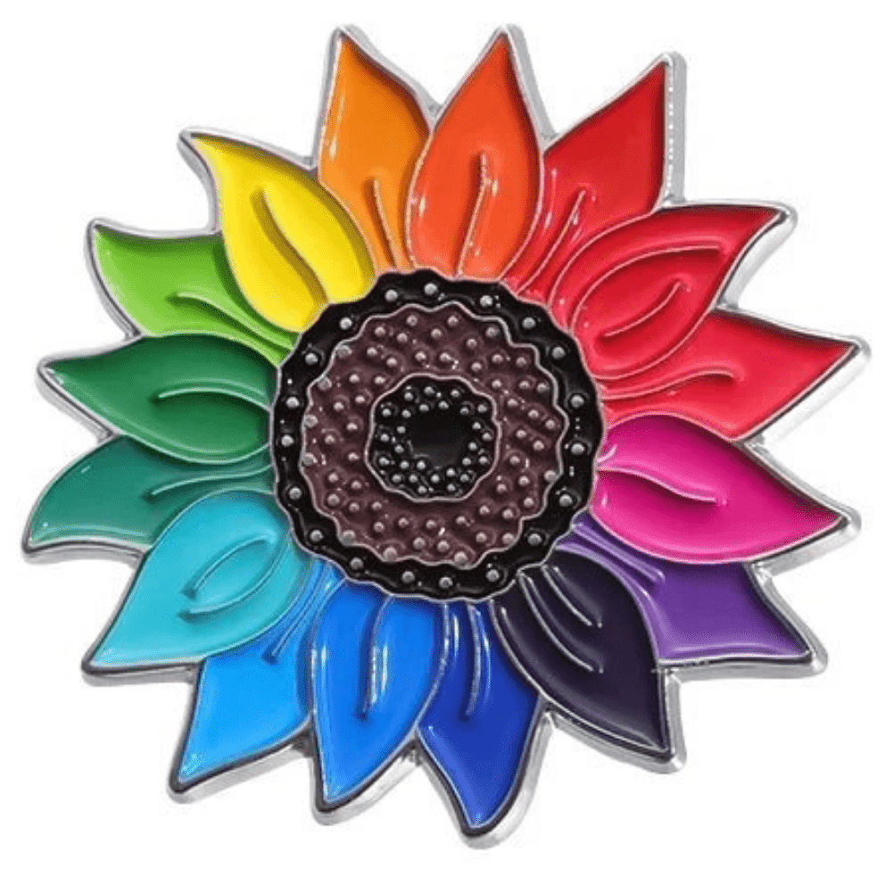 The Rainbow Sunflower enamel pin is a vibrant pride accessory, featuring rainbow-colored petals and a center with small, raised dots. It's perfect for celebrating diversity while adding a splash of color to any attire.