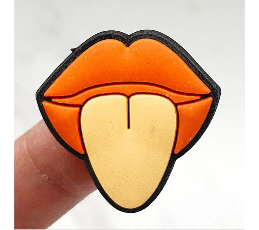 This Retro Roller Skate theme Shoe Charm features a vintage-style cartoon pin of a beige tongue playfully sticking out between bold orange lips and fingers, adding quirky charm and a splash of fun to any collection, just like vibrant orange jibbitz on classic quad skates.