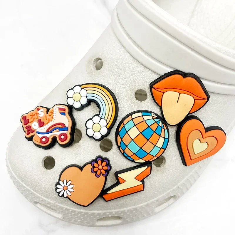 A white shoe decorated with Retro Roller Skate theme Shoe Charms, featuring vibrant orange jibbitz and colorful treasures like a rainbow, disco ball, flowers, lips, roller skate motifs, and lightning bolts in blue and yellow for a vintage vibe.