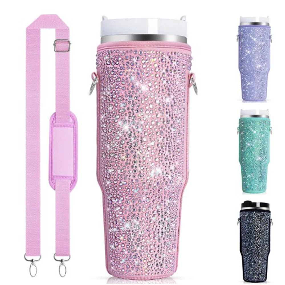 The Shiny Diamante Sleeve for 40oz Stanley Cup by Gay Skate, adorned with pink rhinestones and featuring a detachable adjustable strap, adds flair to your beverage routine. Nearby are vibrant tumblers in purple, teal, and black, each sparkling with rhinestone decorations.