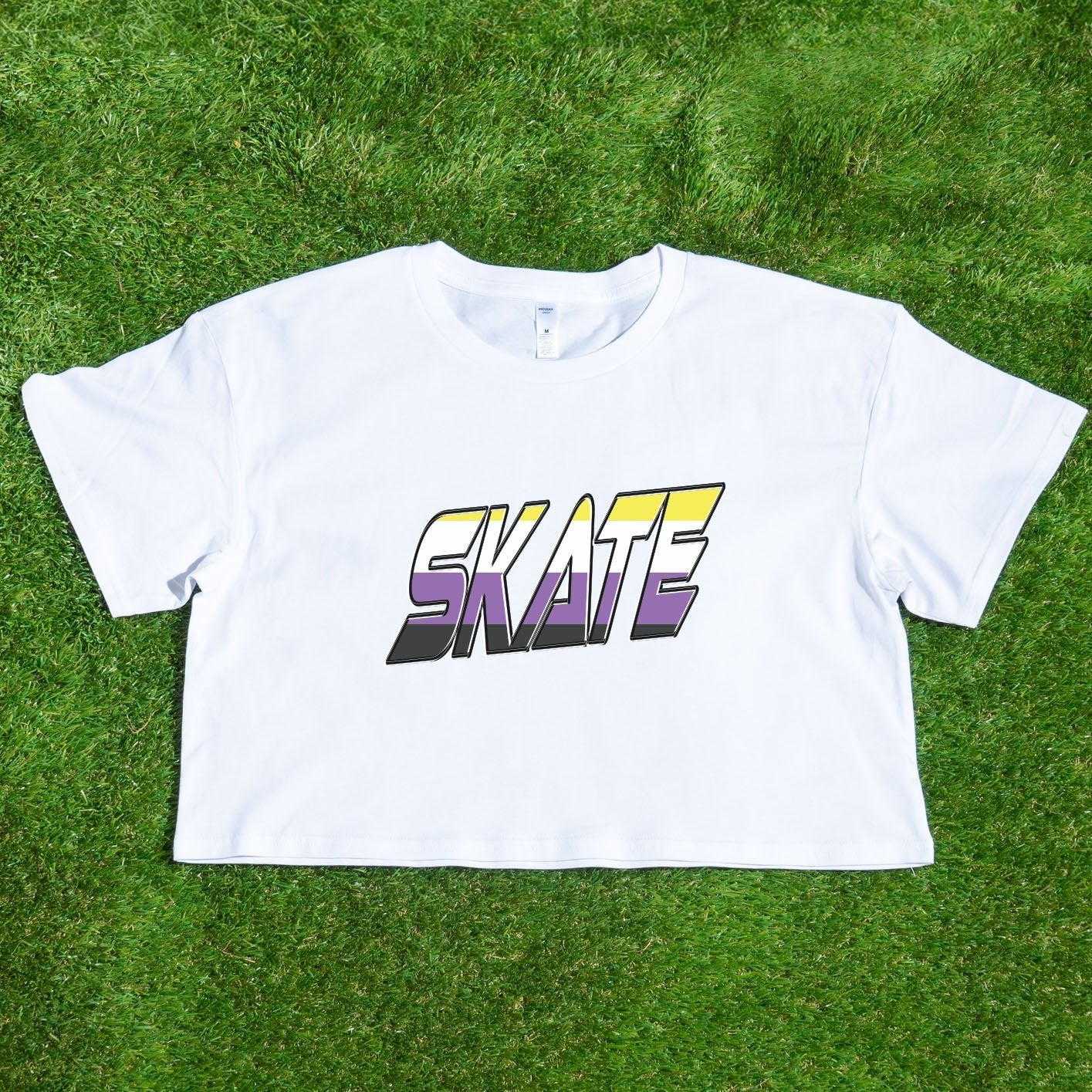 The TRANS RIGHTS original design - locally printed crop tee by Gay Skate is a black cropped T-shirt featuring a vibrant graphic in the center with bold, stylized text reading "TRANS RIGHTS." The design incorporates pastel shades and a lightning bolt motif above the text, celebrating transgender pride.
