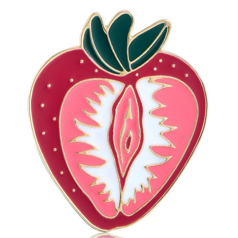 Strawberry Vulva enamel pin features a stylized strawberry that evokes the vulva or vagina with its vibrant red and pink hues, green leaves, and golden outline, making it a bold statement piece for the lesbian community. For WLW, sapphic, lesbian, dykes and sluts