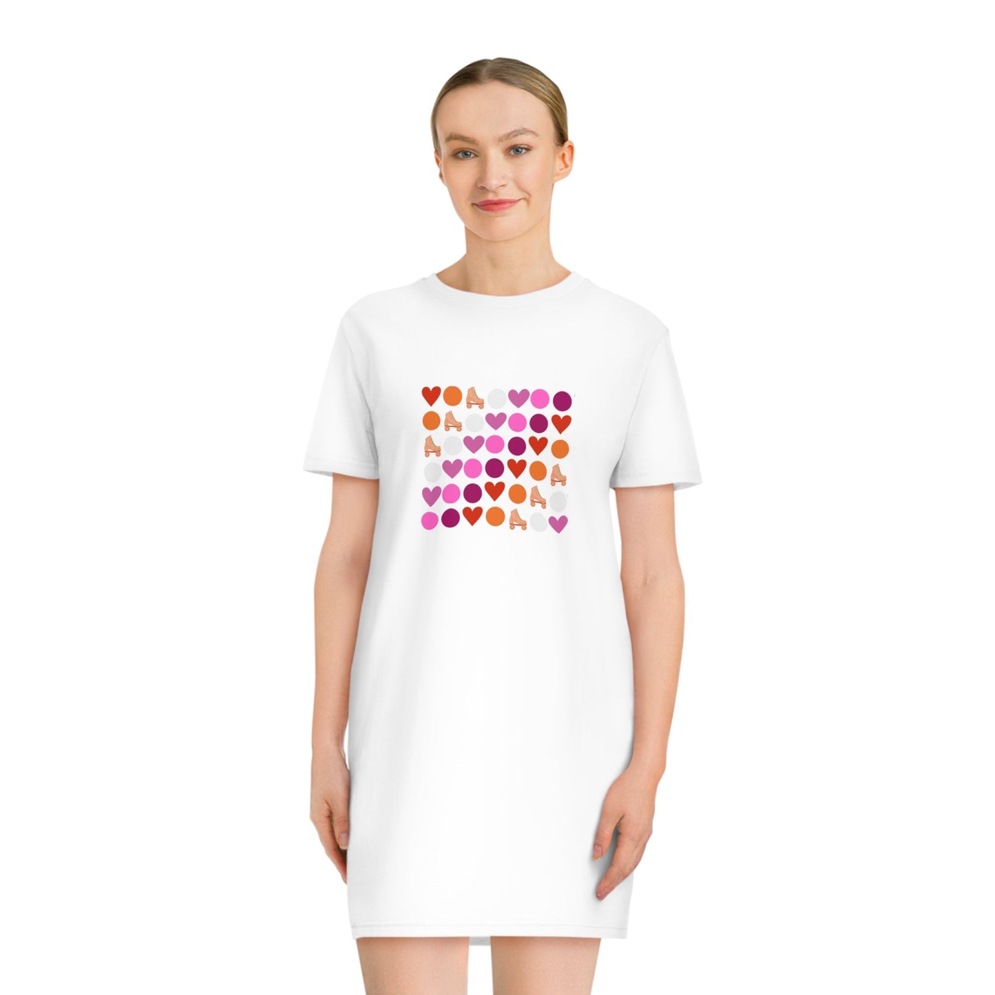 A white Subtle lesbian pride T-Shirt Dress by Printify, made from 100% organic cotton, with a square design on the front featuring a grid of small, colorful hearts in shades of pink, red, orange, and purple. The word "LOVE" is spelled out in the grid with the hearts.