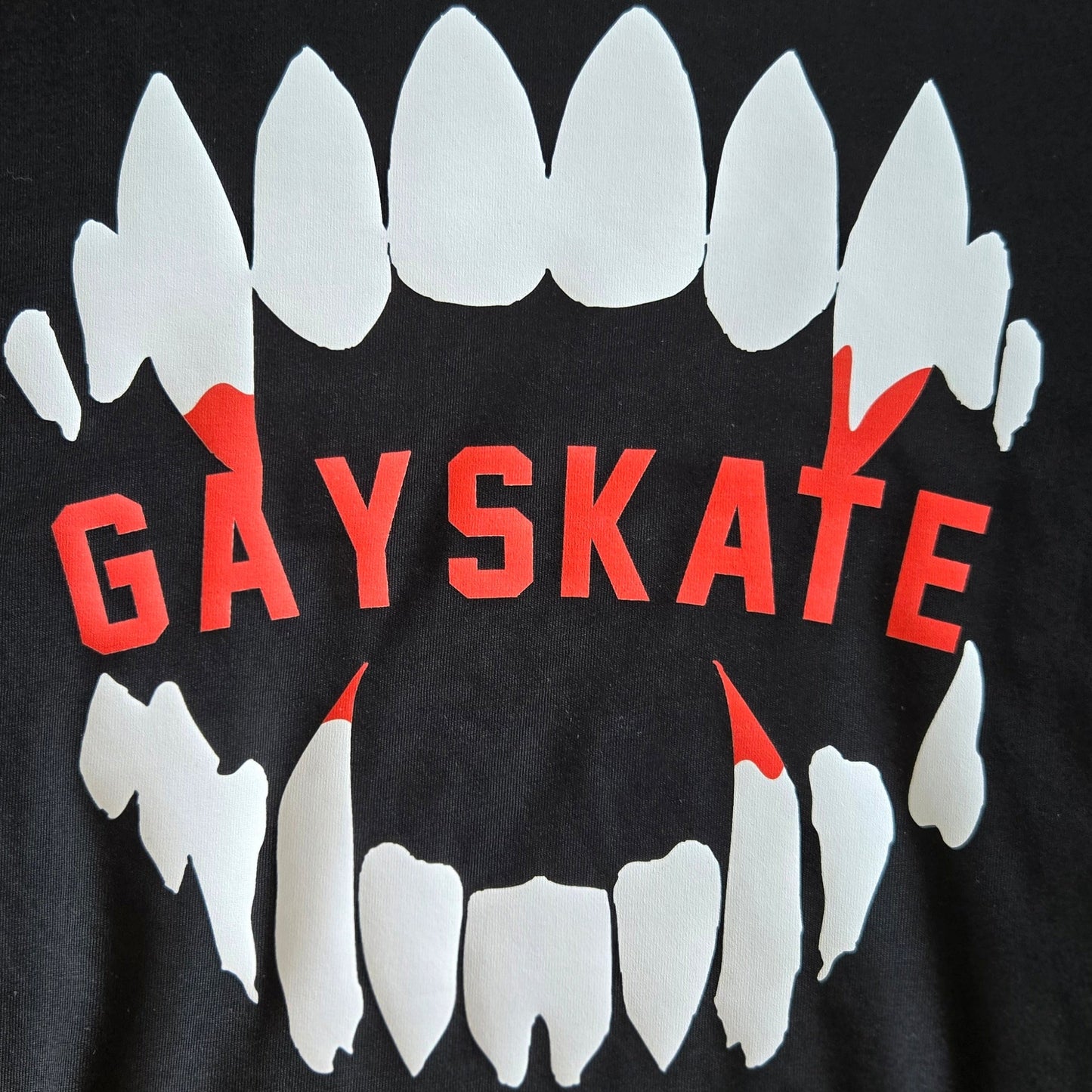 Black t-shirt with vampire white teeth graphic with red blood and 'GAYSKATE' on a black background