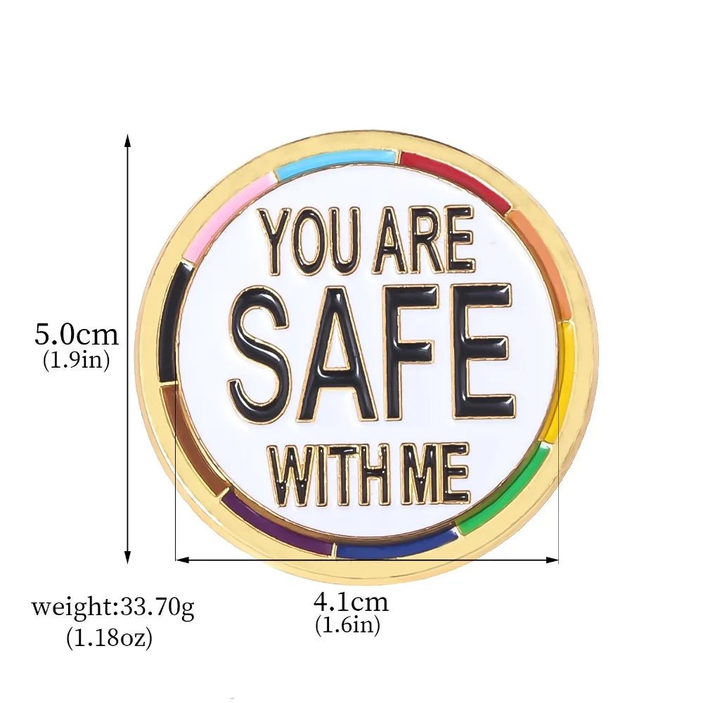 The “You Are Safe With Me - progress pride and gold round pin” features a gold finish, rainbow border, bold text, measures 5 cm x 4.1 cm (2" x 1.6"), and weighs 33.7g—perfect as a pride accessory.