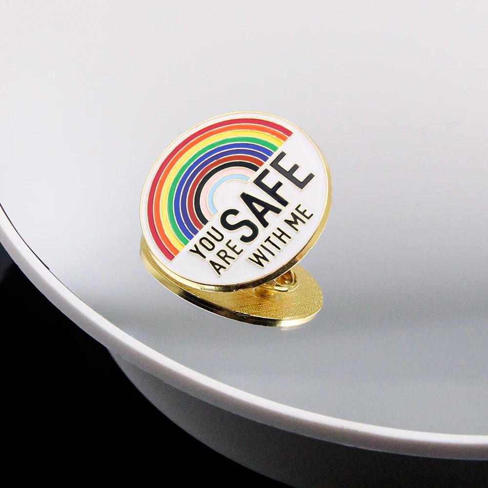 The "You Are Safe With Me" badge features a rainbow design and affirming message—ideal to display with rainbow or trans pride ally badges and key rings for a meaningful, supportive collection.