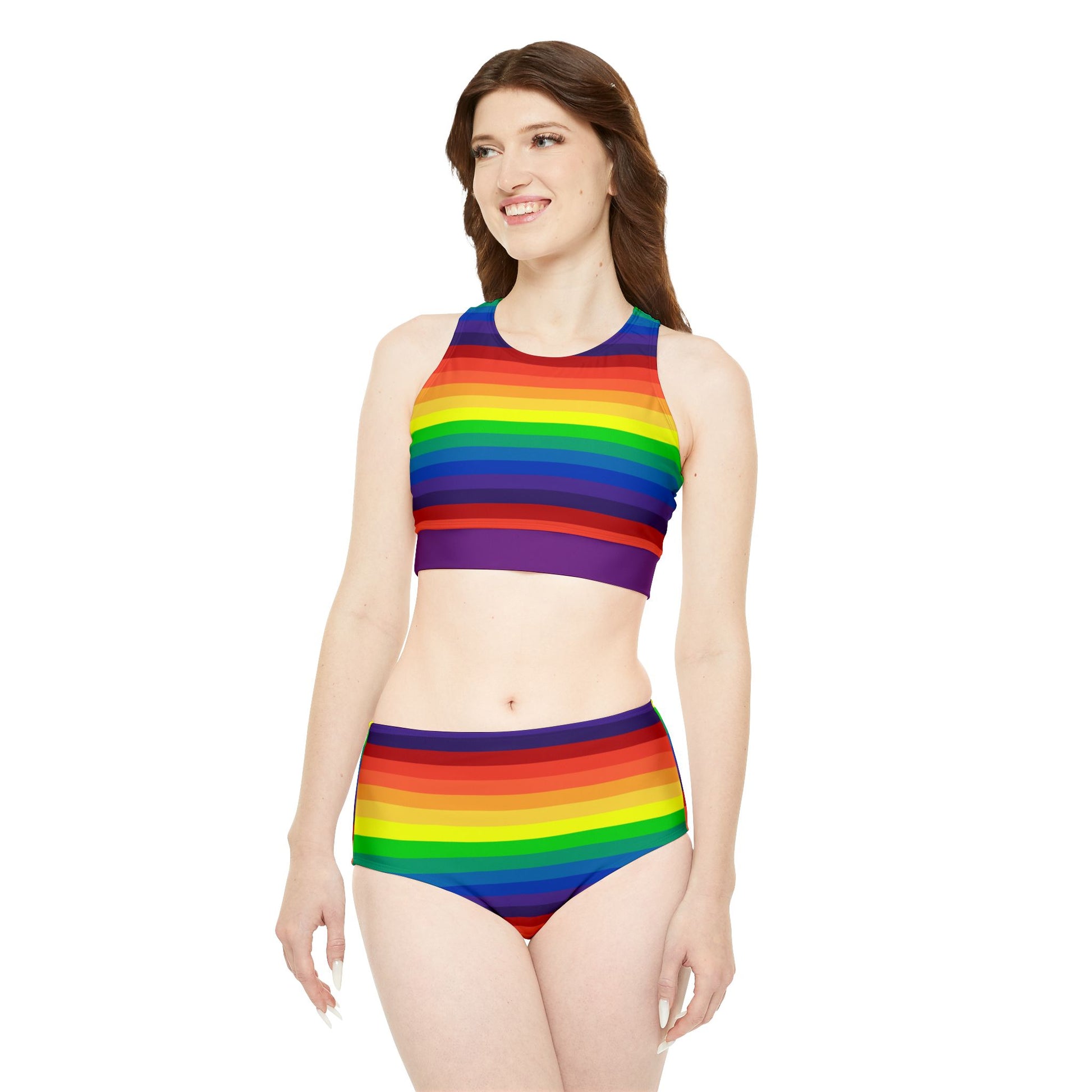 A two-piece "Sporty Swim or Activewear Set - Rainbow Pride Flag" from Printify lays flat against a white background. It features horizontal rainbow stripes in vibrant colors such as red, orange, yellow, green, blue, and purple. The top boasts a high neckline while the bottom has a flattering high-waisted cut.