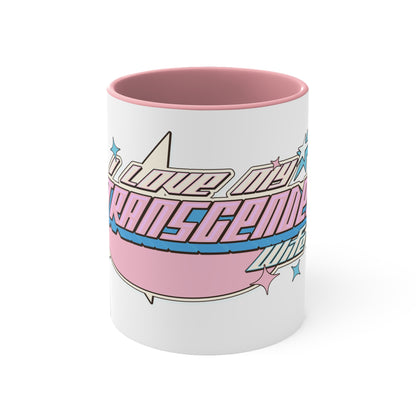 The Printify "I Love My Transgender Wife" original design accent mug is a white ceramic mug with a pink interior, showcasing a retro-styled design of pink, blue, and white stripes. The text on the mug reads "I LOVE MY TRANSGENDER LIFE" surrounded by colorful stars.