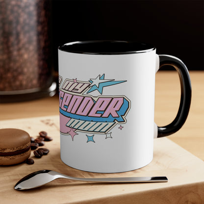 The "I Love My Transgender Mom" original design accent mug by Printify is a striking white ceramic mug with a pink interior. It showcases bold, colorful text that reads, "You Love Me? Transcend It!" in a retro-futuristic font accompanied by stars and pastel shades of pink, blue, and cream. The vibrant color contrast ensures this unique transgender mom mug truly stands out.