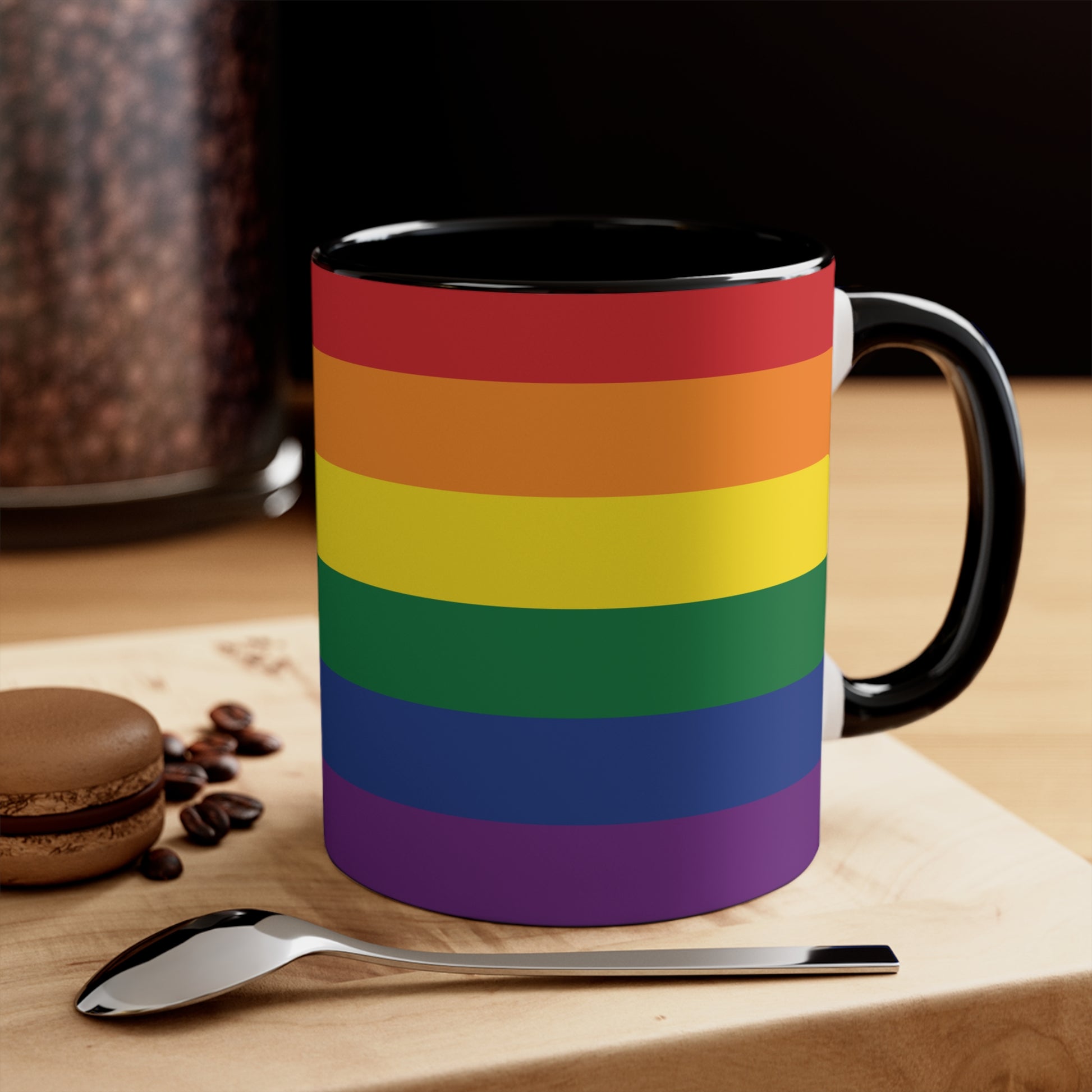 The Rainbow Pride Flag Colorful Accent Mug by Printify is a white ceramic mug featuring a red handle and interior. The exterior showcases horizontal stripes in the vibrant colors of the LGBTQ+ pride flag—red, orange, yellow, green, blue, and purple—offering a striking color contrast.