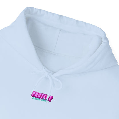 Close-up of the Protect Trans Kids Hoodie - Australian Shipping, a white ethically grown cotton hoodie with "PROTECT what's next" near the neckline in pink and green. This unisex heavy blend sweatshirt has a drawstring and slightly raised hood for comfort.