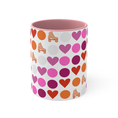 The Subtle Lesbian Pride + Roller Skate Colourful Accent Mug by Printify is a white ceramic mug featuring a red handle and a vibrant interior. It is adorned with a playful pattern of hearts, circles, and roller skates in an array of colors, including pink, purple, orange, and red.