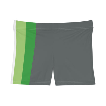 A person is shown from the side wearing Printify's Aromantic Pride Flag Short Shorts, featuring vertical stripes in black, gray, white, green, and dark green. The unisex activewear shorts fit snugly, with the person's hand relaxed by their side against a white background.