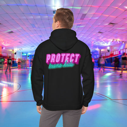 A person in a high-quality Protect Trans Kids Original Hoodie from Printify, crafted from ethically grown cotton, glides effortlessly at a vibrant roller rink illuminated by neon lights. The bold, colorful lettering on their hoodie reads "PROTECT trans kids," while other skaters create a lively, blurred backdrop.