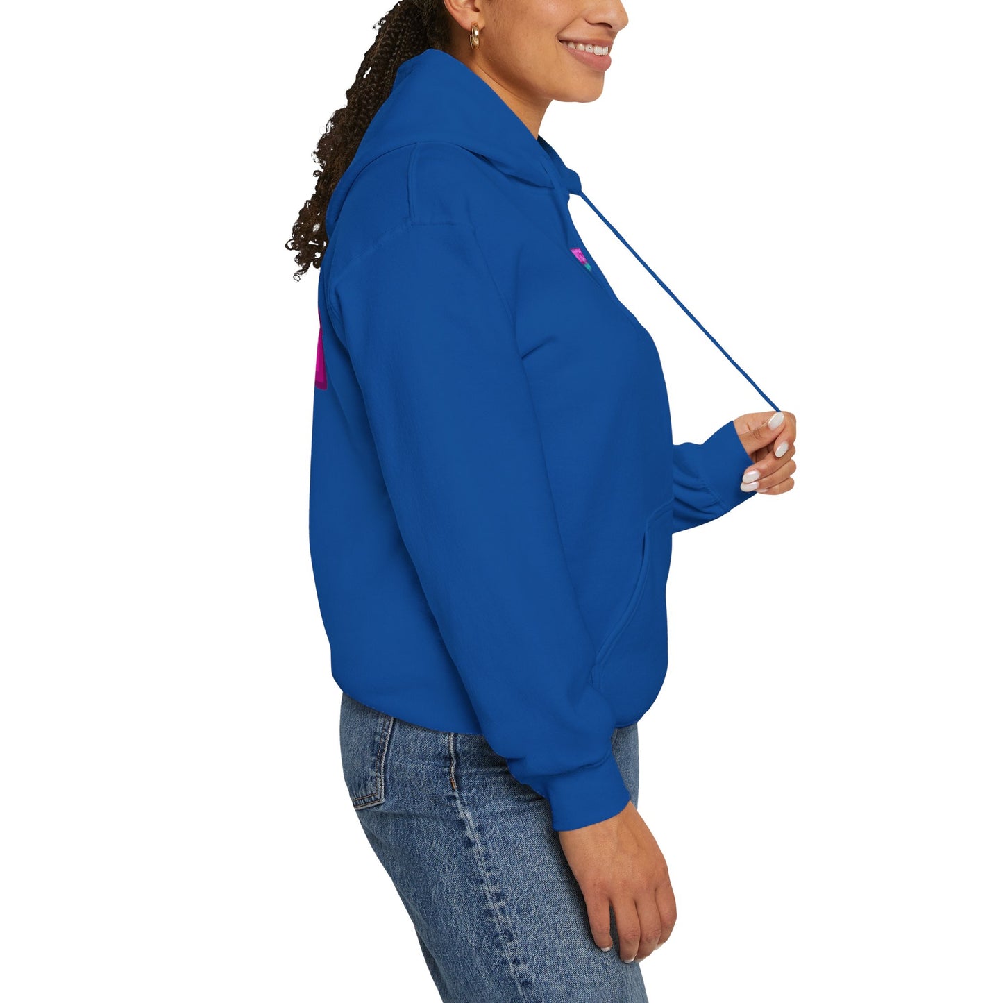 A person stands sideways wearing the Protect Trans Kids Hoodie - Australian Shipping in bright blue. Their long, curly hair is tied back as they gently hold the hoodie drawstring with jeans against a plain white backdrop. This stylish piece offers comfort and conscious fashion from ethically grown cotton.