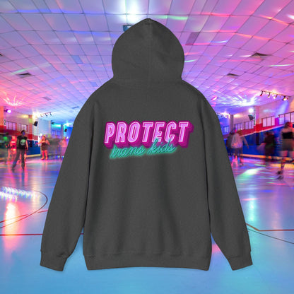 A unisex "Protect Trans Kids" hoodie, crafted from ethically grown cotton, is displayed. The bold pink and green lettering stands out against a vibrant background of a neon-lit roller skating rink with people in the distance.