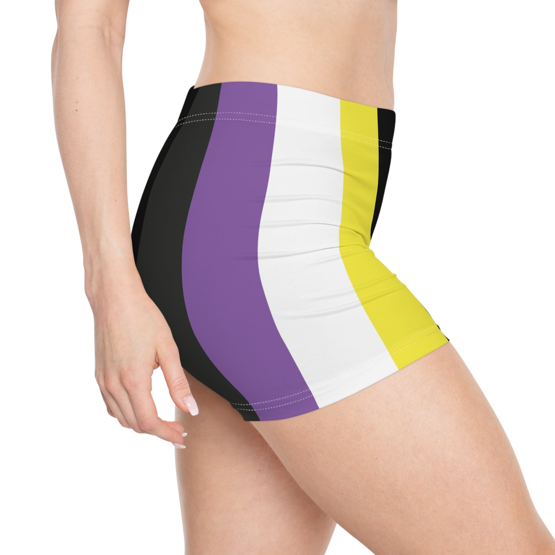 A person is modeling the Non-Binary Pride Flag Short Shorts by Printify, featuring high-waisted custom stripes in black, purple, white, and yellow. Made from moisture-wicking fabric that includes polyester and spandex, the shorts are displayed from the lower torso to the upper thigh.