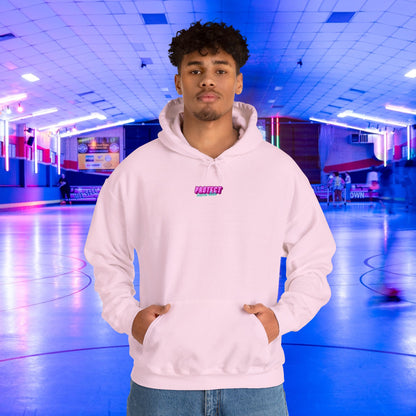 A person wearing a "Protect Trans Kids" hoodie stands in a neon-lit roller skating rink. The background glows with blue and purple lights, while others skate in the distance.