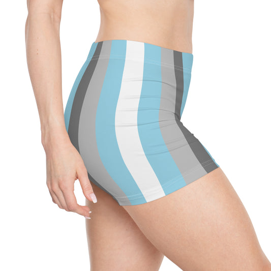 A person is modeling the Demiboy Pride Flag Short Shorts by Printify, featuring high-waisted, active wear with vertical stripes in various shades of blue, gray, and white. Only the lower torso and upper thighs are visible in the image, highlighting the snug fit and moisture-wicking fabric of these stylish shorts.