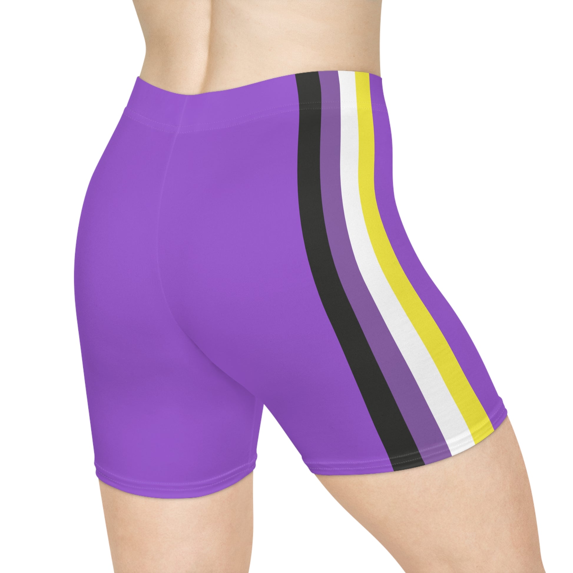 A person is wearing Non-binary Pride Flag Bike pants, featuring moisture-wicking polyester material and vertical stripes in black, purple, white, and yellow on the side - the nonbinary pride flag. The image shows the lower torso and upper thigh area from a side view.