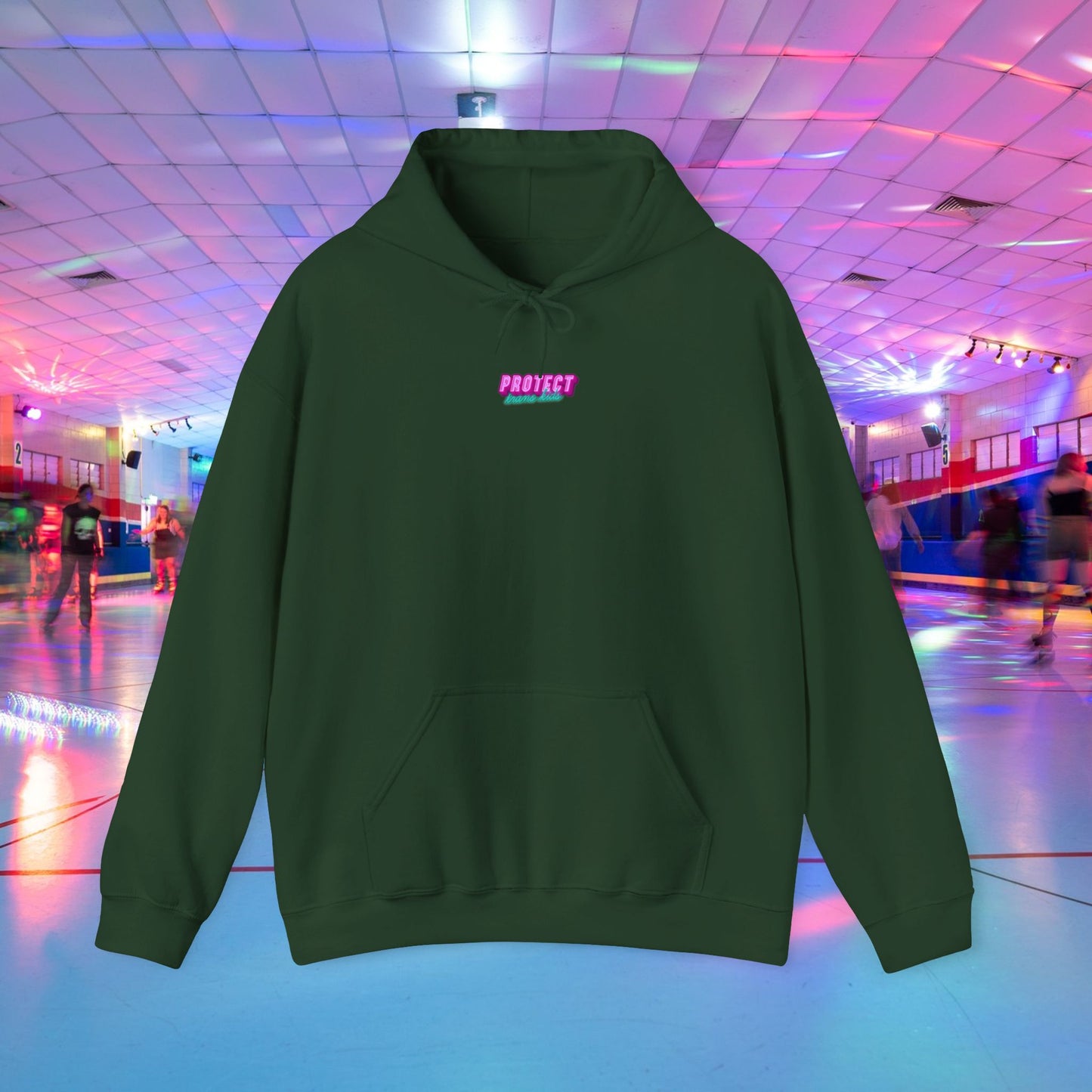 A "Protect Trans Kids" unisex hoodie in forest green, made from ethically grown cotton, showcases the word "PROJECT" in pink on the chest against a lively roller skating rink with glowing lights. Available for Australian shipping.