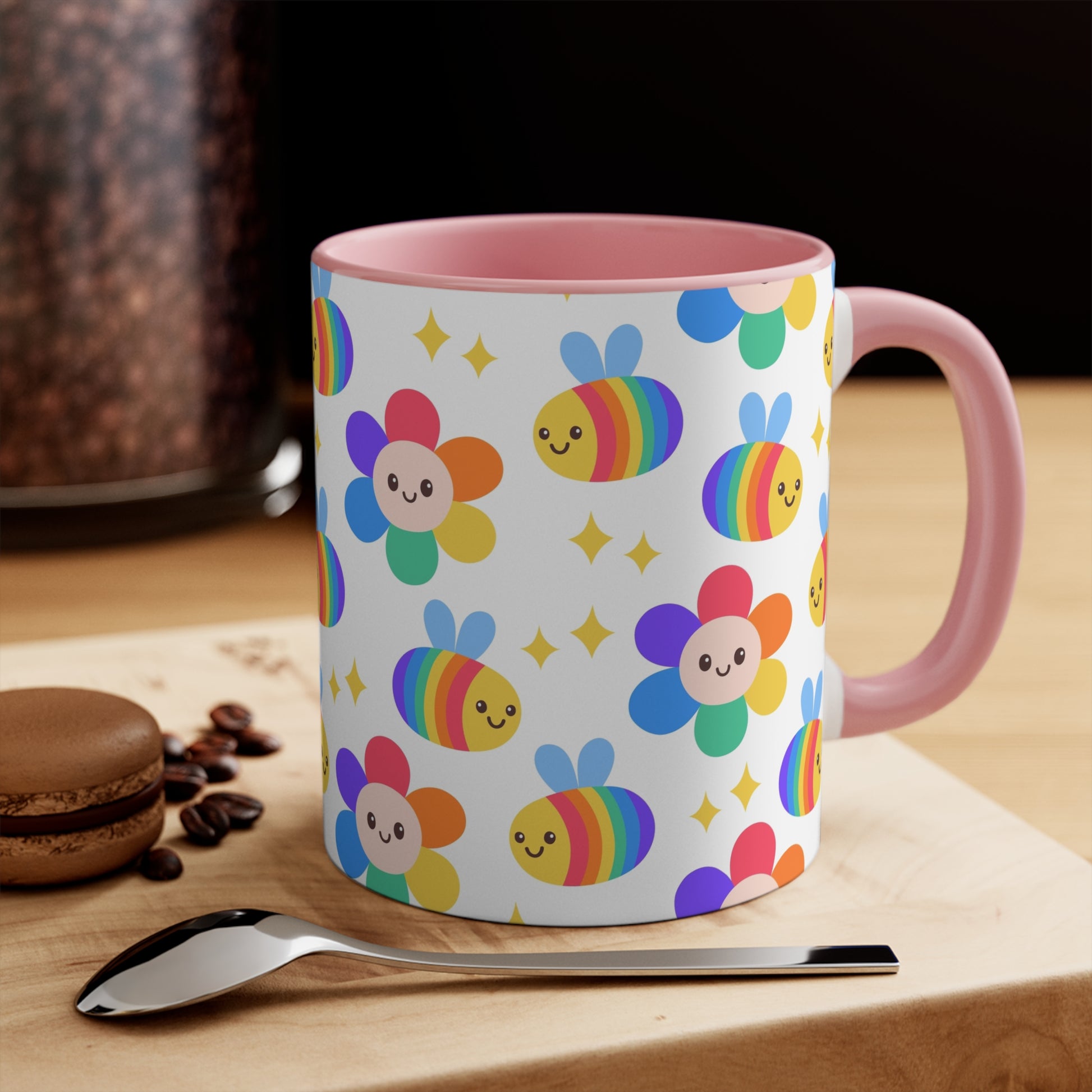 The Subtle Rainbow Pride - Flowers and Bees Colourful Accent Mug  is a white ceramic mug with a red handle and colored interior, adorned with a vibrant pattern of adorable smiling rainbow bees and flower designs. The cheerful bees and flowers are rendered in bright rainbow colors reminiscent of the pride flag, with small yellow stars scattered throughout. Perfect subtle rainbow pride flag cup