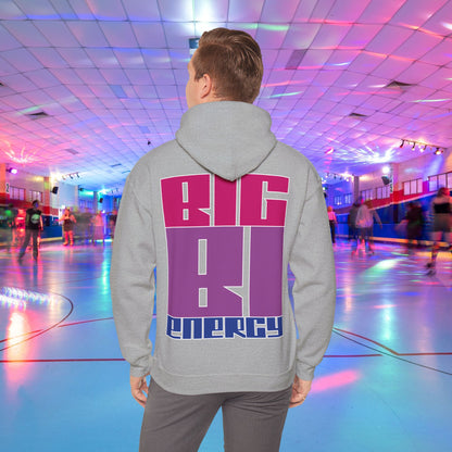 A person with light brown hair is wearing a high-quality BIG BI ENERGY Hoodie from GAY SKATE, featuring bold, Bisexual Pride Flag colour letters on the back. They are standing in a roller skating rink illuminated with vibrant, colorful lights. The cozy feel and warmth of this trans and queer-owned brand is evident.