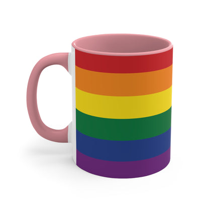 The Rainbow Pride Flag Colorful Accent Mug by Printify is a white ceramic mug featuring a red handle and interior. The exterior showcases horizontal stripes in the vibrant colors of the LGBTQ+ pride flag—red, orange, yellow, green, blue, and purple—offering a striking color contrast.