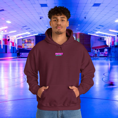 In a neon-lit roller skating rink, someone confidently wears the "Protect Trans Kids Hoodie" in maroon, made from ethically grown cotton.