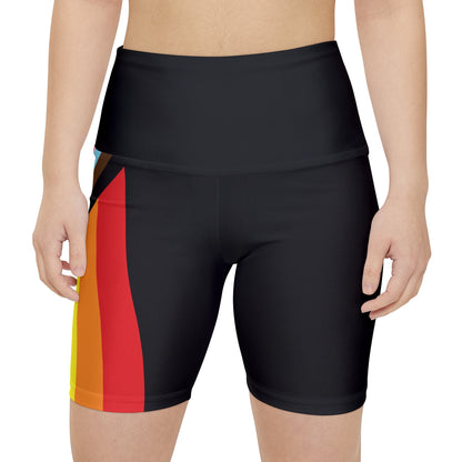 A person wearing Printify's Progress Pride Rainbow Flag High-Waisted Workout Pants, featuring a vibrant design perfect for an active lifestyle. The shorts display horizontal stripes in black, brown, light blue, pink, white, red, orange, yellow, green, and blue against a white background.