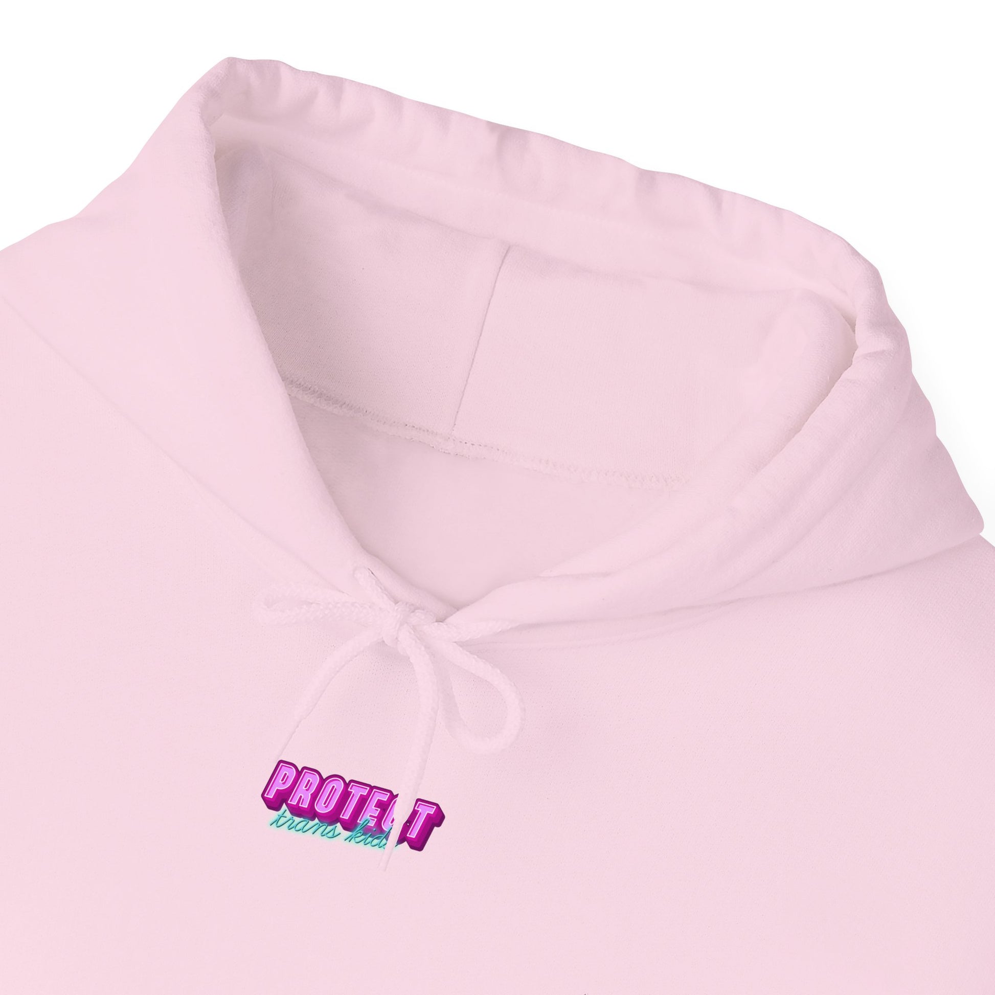 Close-up of a light pink Protect Trans Kids Hoodie in a unisex heavy blend. It features "PROTECT" in multicolored embroidery, ethically grown cotton, and a neck drawstring for style and comfort—Australian shipping available.