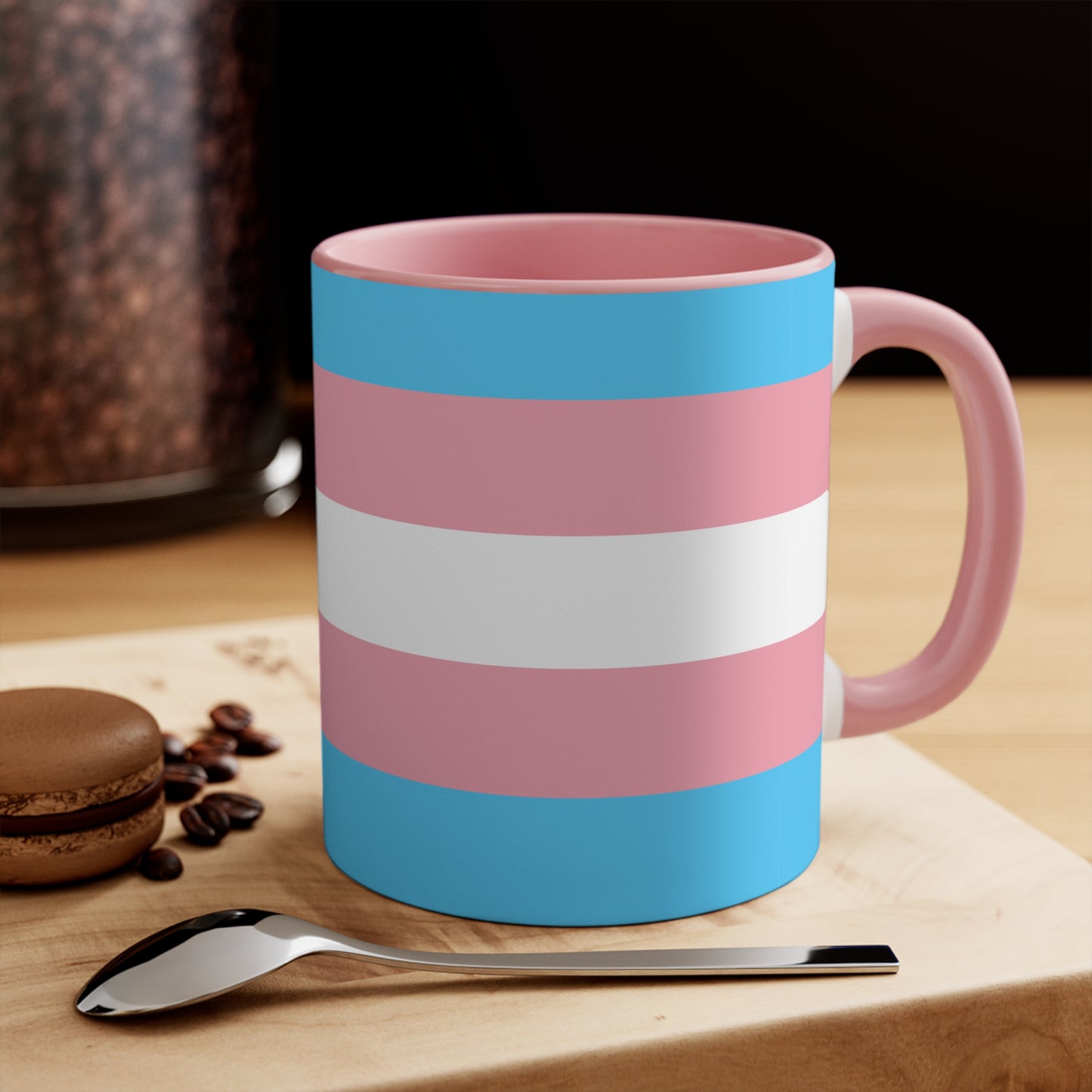 The Trans Pride Flag Colourful Accent Mug by Printify features a ceramic design with horizontal stripes in blue, pink, and white. Its solid blue handle perfectly complements the colorful interior.