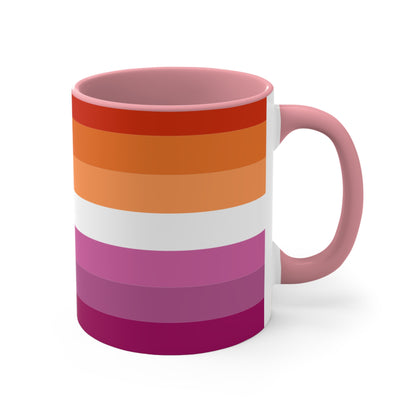 The Lesbian pride flag colorful accent mug by Printify features a vibrant design with horizontal stripes in varying shades of orange, pink, and purple. It has a red handle and colorful interior that create an eye-catching contrast against the plain white background.