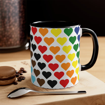 Introducing the Progress Pride Flag Love Hearts - Colourful Accent Mug by Printify: a ceramic mug featuring a vibrant red handle and a lively interior, adorned with diagonally arranged rows of hearts in shades of purple, blue, pink, green, and yellow. The hearts are evenly spaced across the surface, creating a charming and festive design.