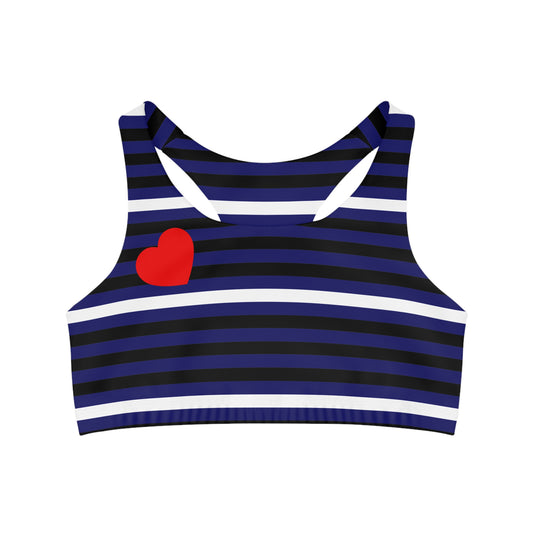 The Leather Pride Flag Sports Crop Top showcases moisture-wicking fabric with navy and black stripes, white accent lines, and a striking red heart design on the left. It features wide straps and a racerback style, making it an ideal choice for intense workouts while keeping you fashionable and comfortable. BDSM pride bondage dom sub sadomasochism