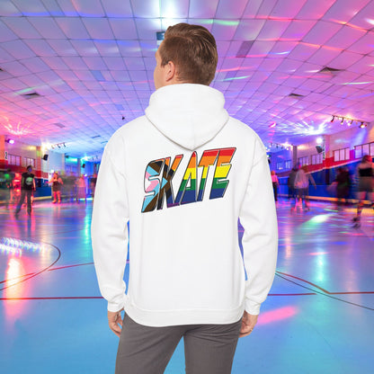 A person with short hair is wearing a GAYSKATE SKATE Progress Pride Hoodie, showcasing a rainbow pride flag gradient "SKATE" design on the back. They are facing away from the camera in a roller skating rink illuminated by vibrant, colorful lights and surrounded by other skaters.